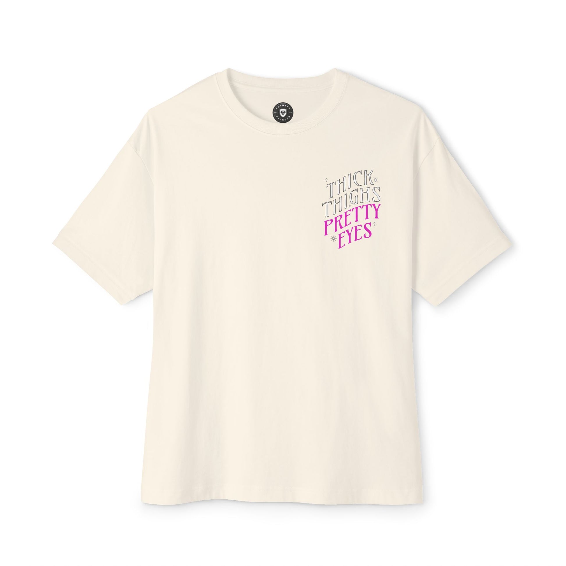 Beige t-shirt with 'THICK THIGHS PRETTY EYES' text on a white background