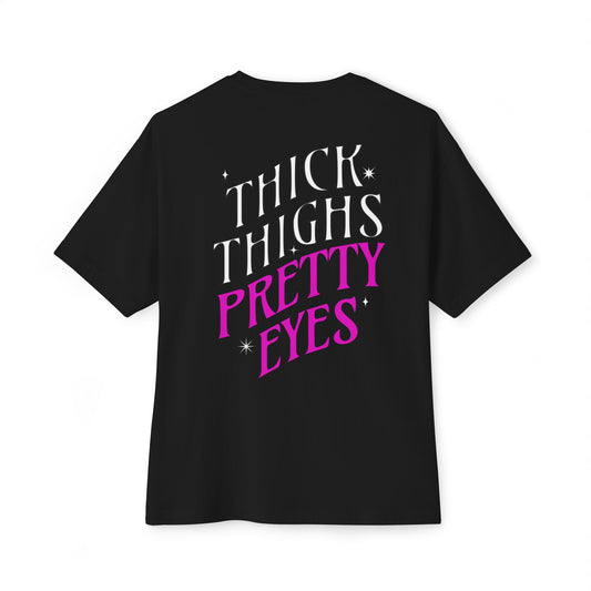 Black t-shirt with 'THICK THIGHS PRETTY EYES' text on a white background