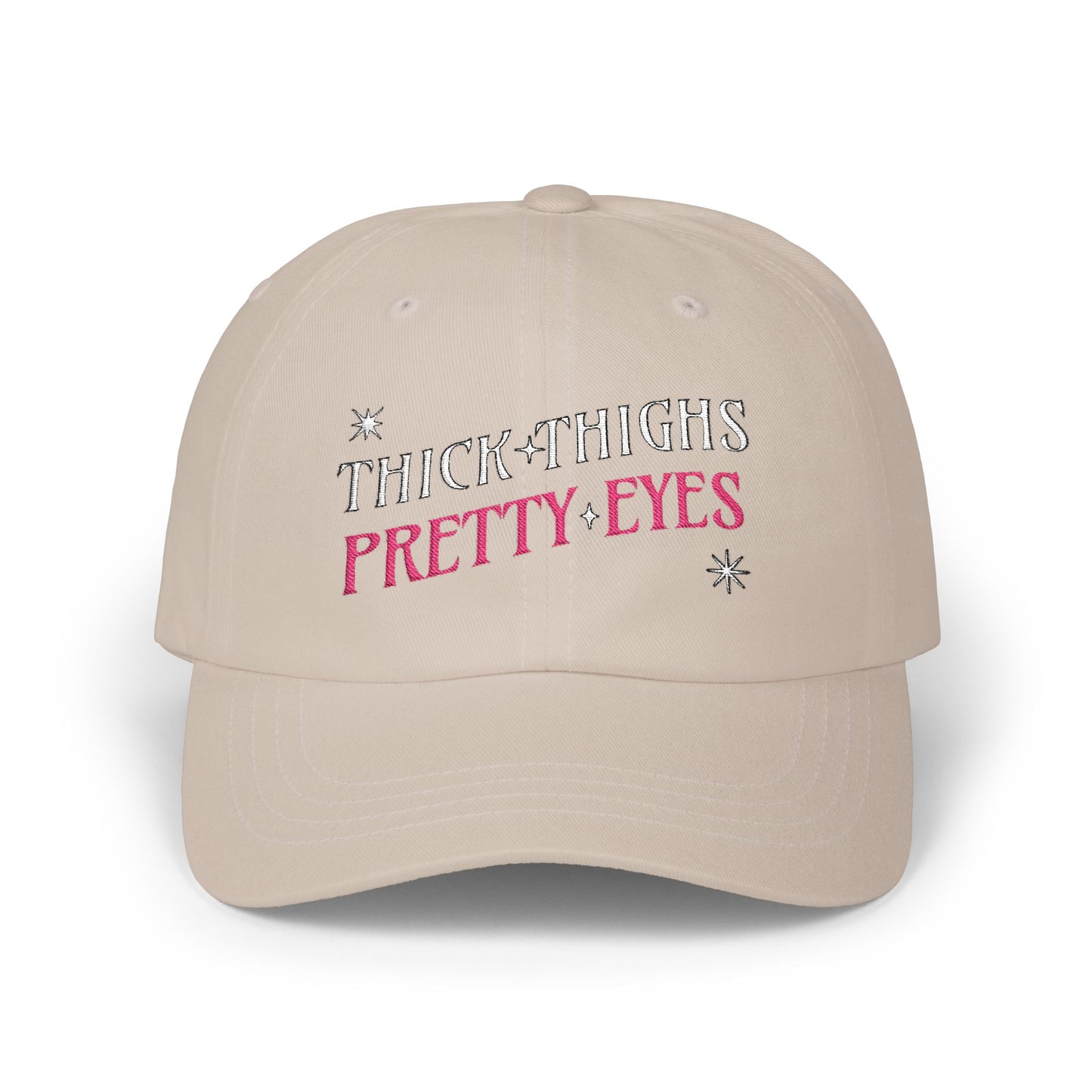 Beige cap with 'THICK THIGHS PRETTY EYES' text on a white background