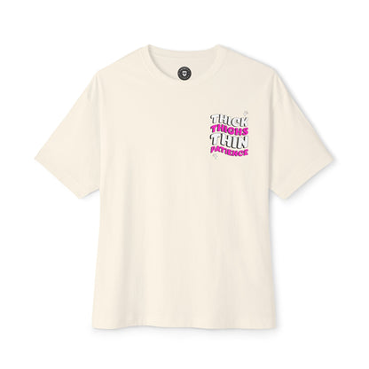 Beige t-shirt with pink and black text on a white background
