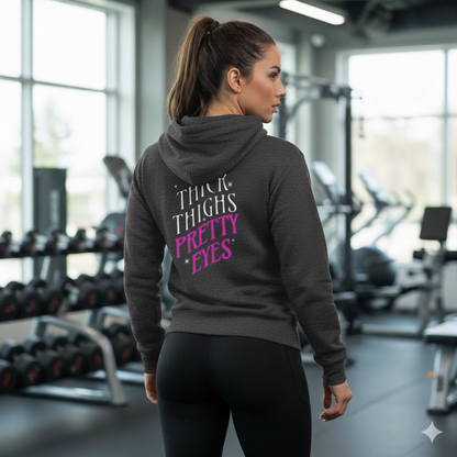 Woman wearing a hoodie with text in a gym setting